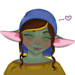 A green goblin with brown hair and large round ears that are pink inside wears a blue headdress called a Dikhlo. They are grinning cutely with sharp little teeth and closed eyes. They have dark red cheeks with little white freckles and a floating heart